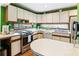 Bright kitchen features white cabinets, stainless steel appliances, and views of the yard at 131 Cypress St, Roswell, GA 30075
