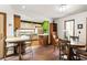 Bright eat-in kitchen with white cabinets, bar-style seating, and brick flooring at 131 Cypress St, Roswell, GA 30075