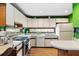 Well lit kitchen offers stainless appliances, bright lighting, and white cabinetry at 131 Cypress St, Roswell, GA 30075