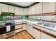 Bright kitchen with white cabinets, stainless steel appliances, and expansive countertops at 131 Cypress St, Roswell, GA 30075