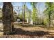 Outdoor view of a rustic stone structure in a wooded area with lush greenery and a view of the home at 131 Cypress St, Roswell, GA 30075