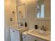 Bright bathroom featuring double sinks, white cabinets, and white vanity mirror at 1380 Cedar Hl, Douglasville, GA 30134