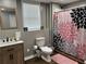 Stylish bathroom featuring a single vanity, wood look flooring, and a shower with a decorative curtain at 1380 Cedar Hl, Douglasville, GA 30134