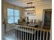 Stylish dining room features a modern light fixture over a wooden table and upholstered chairs at 1380 Cedar Hl, Douglasville, GA 30134