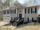 Charming two-story home with gray siding, stone accents, and a welcoming front porch with black shutters at 1380 Cedar Hl, Douglasville, GA 30134