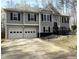 Inviting two-story home featuring a two-car garage, gray siding, and a landscaped front yard on a sunny day at 1380 Cedar Hl, Douglasville, GA 30134