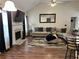 Spacious living room featuring a fireplace, large sectional sofa, and wood flooring for a comfortable ambiance at 1380 Cedar Hl, Douglasville, GA 30134