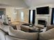Cozy living room with a fireplace, TV, comfortable seating, and neutral decor for relaxation and entertainment at 1380 Cedar Hl, Douglasville, GA 30134