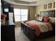 Comfortable main bedroom features a large bed, dressers, tv, and window at 1380 Cedar Hl, Douglasville, GA 30134