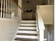 Interior view of the staircase leading upstairs, showcasing the railing and natural light at 1380 Cedar Hl, Douglasville, GA 30134