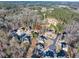 An aerial shot showcasing the house in a cul-de-sac surrounded by lush greenery in a quiet neighborhood at 1526 Rocky River Dr, Lawrenceville, GA 30045