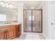 This bathroom features tiled floors, a granite countertop vanity and a glass-framed shower at 1526 Rocky River Dr, Lawrenceville, GA 30045