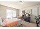 A furnished bedroom features carpet and a window with blinds at 1526 Rocky River Dr, Lawrenceville, GA 30045