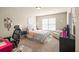 A furnished bedroom features carpet, a window, and desk space at 1526 Rocky River Dr, Lawrenceville, GA 30045