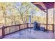 Spacious wood deck with seating overlooking a wooded backyard at 1526 Rocky River Dr, Lawrenceville, GA 30045