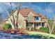 Charming two-story home featuring a brick and stone facade, covered porch and beautifully landscaped yard at 1526 Rocky River Dr, Lawrenceville, GA 30045