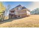 A beautiful home featuring a multi-level deck and traditional style with a brick foundation at 1526 Rocky River Dr, Lawrenceville, GA 30045
