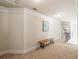 Hallway with a small bench, neutral walls and carpet, and white trim at 1526 Rocky River Dr, Lawrenceville, GA 30045