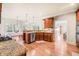 Open-concept kitchen featuring granite counters, stainless steel appliances, and hardwood floors at 1526 Rocky River Dr, Lawrenceville, GA 30045