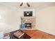 Cozy living room showcasing stone fireplace, hardwood floors, and comfortable furniture at 1526 Rocky River Dr, Lawrenceville, GA 30045