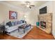 Inviting living room with a stone fireplace, comfortable seating, and hardwood floors at 1526 Rocky River Dr, Lawrenceville, GA 30045