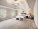 Spacious main bedroom features trey ceiling, sitting area and neutral carpeting at 1526 Rocky River Dr, Lawrenceville, GA 30045