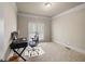 Bright office featuring neutral carpet, large window, and modern desk at 1526 Rocky River Dr, Lawrenceville, GA 30045