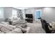 Basement living room with comfortable seating, gaming chair, and TV at 5081 Stone Moss Way, Hoschton, GA 30548