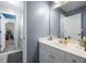 A bathroom featuring a white vanity with a framed mirror at 5081 Stone Moss Way, Hoschton, GA 30548