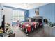 Fun bedroom with blue walls, a large window, and red, black, and white bedding at 5081 Stone Moss Way, Hoschton, GA 30548