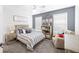 A bedroom featuring a striped bedspread and a ceiling fan at 5081 Stone Moss Way, Hoschton, GA 30548