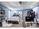 A bedroom with blue walls, carpet floors, and a ceiling fan at 5081 Stone Moss Way, Hoschton, GA 30548
