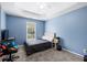 Comfortable bedroom featuring soft blue walls, neutral carpet, and a white ceiling fan at 5081 Stone Moss Way, Hoschton, GA 30548