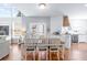 Open-concept dining area with a breakfast bar, hardwood floors, and lots of natural light at 5081 Stone Moss Way, Hoschton, GA 30548