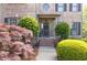Elegant front entrance with manicured landscaping, brick steps, and a decorative wreath at 5081 Stone Moss Way, Hoschton, GA 30548