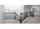 A hallway with hardwood railing and carpet flooring at 5081 Stone Moss Way, Hoschton, GA 30548