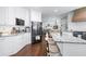 Spacious kitchen featuring white cabinetry, granite countertops, an island, stainless steel appliances, and hardwood floors at 5081 Stone Moss Way, Hoschton, GA 30548