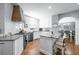 Bright kitchen features white cabinets, granite countertops, stainless appliances, and a spacious center island at 5081 Stone Moss Way, Hoschton, GA 30548