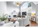 Open living room with high ceilings, large windows, fireplace, and neutral color palette at 5081 Stone Moss Way, Hoschton, GA 30548