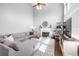 Bright living room features high ceilings, a fireplace, and a large sectional couch at 5081 Stone Moss Way, Hoschton, GA 30548