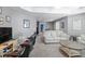 Spacious living room with entertainment center, comfortable seating, and bright lighting at 5081 Stone Moss Way, Hoschton, GA 30548