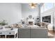 Bright living room features high ceilings, a fireplace, and large windows for natural light at 5081 Stone Moss Way, Hoschton, GA 30548