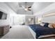 Spacious main bedroom with ceiling fan, tray ceiling, sitting area and walk-in closet at 5081 Stone Moss Way, Hoschton, GA 30548