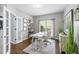 A well-lit office with French doors, desk, chair, and decorative plants, showcasing a workspace at 5081 Stone Moss Way, Hoschton, GA 30548