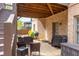 Back patio with table, chairs, grill, and a wood-burning stove at 5081 Stone Moss Way, Hoschton, GA 30548