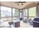 Comfortable screened-in porch with ceiling fan and outdoor furniture at 5081 Stone Moss Way, Hoschton, GA 30548