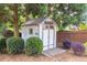 Outdoor shed with charming design, surrounded by lush greenery and a wooden fence at 5081 Stone Moss Way, Hoschton, GA 30548
