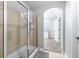 Walk-in shower featuring sliding glass door and tiled walls at 5081 Stone Moss Way, Hoschton, GA 30548