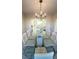 Elegant dining room featuring chandelier, table and view into living room with new marble-patterned tile flooring at 771 Franklin Mill Trce, Loganville, GA 30052