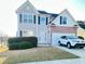 Charming two-story home with a well-manicured lawn and a white SUV parked in the driveway at 771 Franklin Mill Trce, Loganville, GA 30052